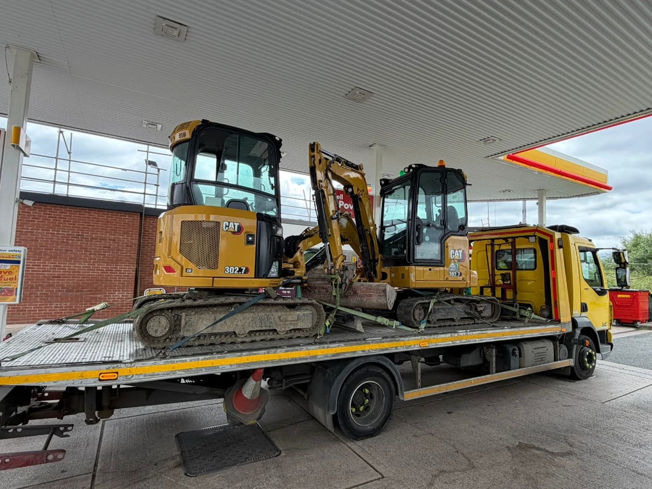 AHS Recovery flatbed lorry transporting excavators